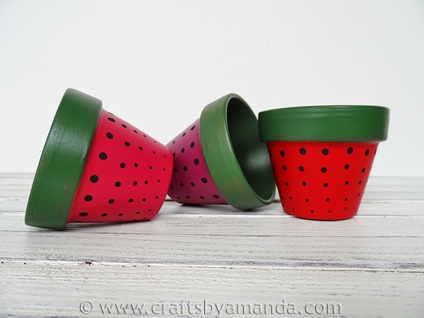 Terra cotta pots painted to look like strawberries from Crafts by Amanda.