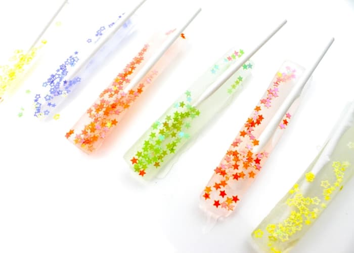 Clear ice cube sticks filled with colorful glitter stars from Life Over C's.