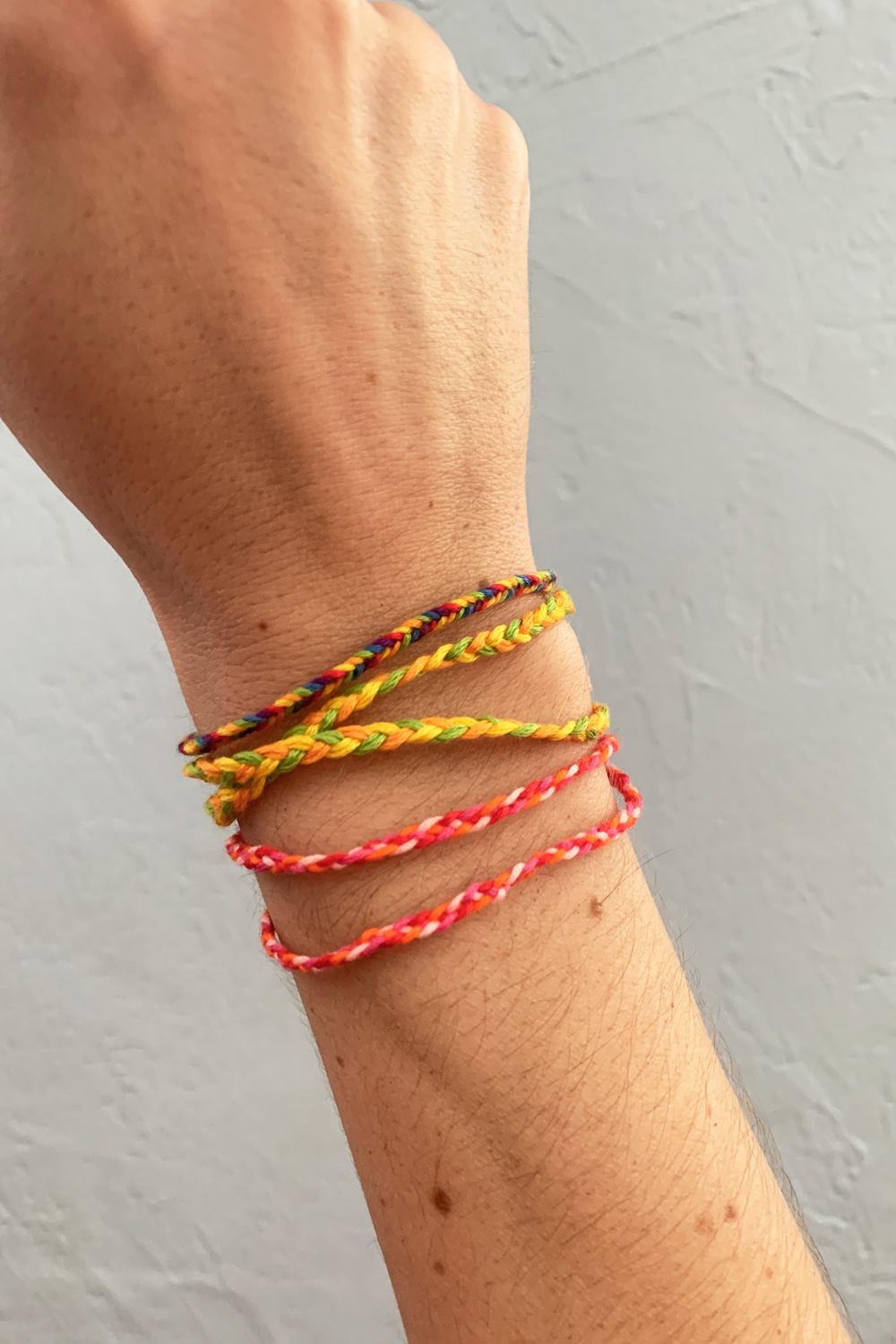 Multi-colored Woven Friendship Bracelets Handmade of Embroidery Bright  Thread with Knots on Light Gray Background Stock Image - Image of creative,  bangle: 193788105