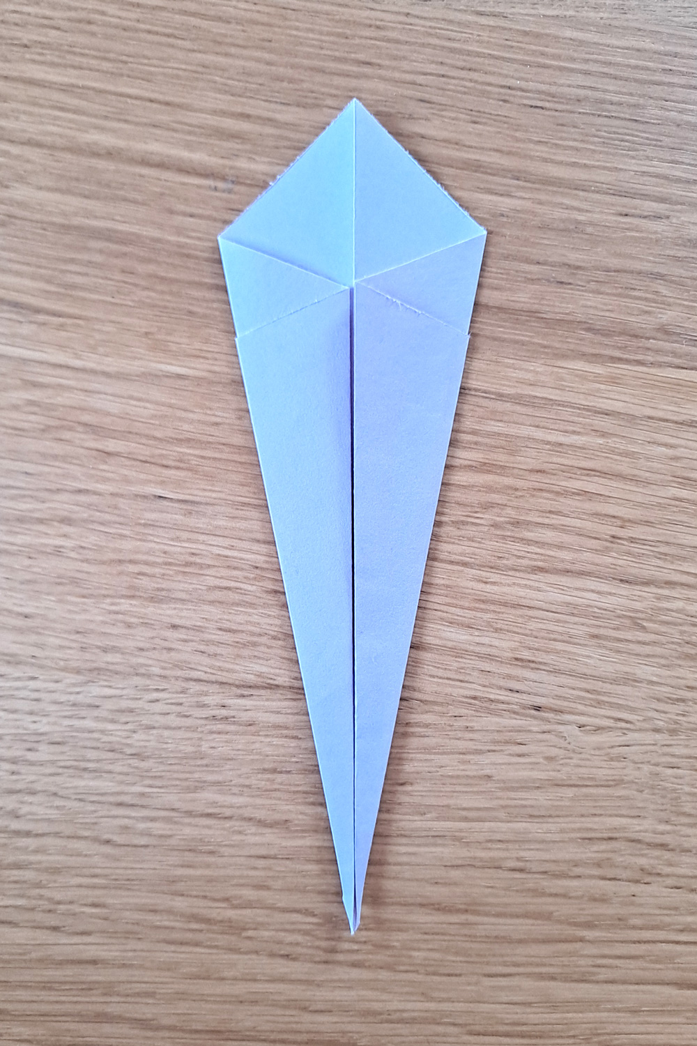 Origami folded skinny kite shape.