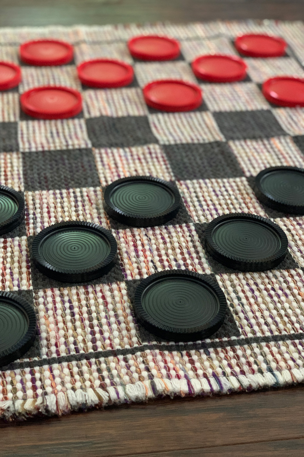 Closeup of game play with pieces on the dark squares.