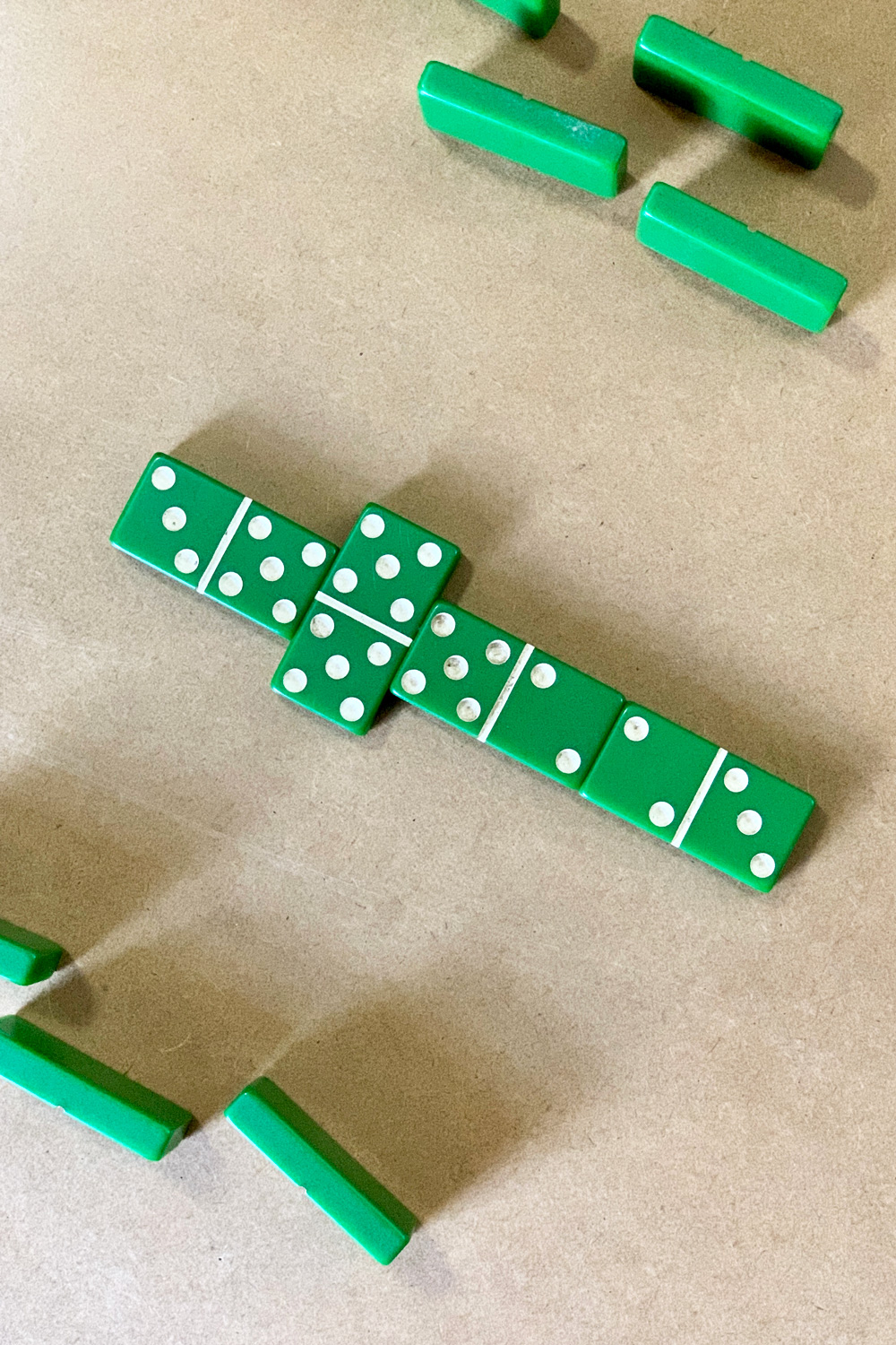 A line of 4 dominoes with a double 5 in the center as the spinner.