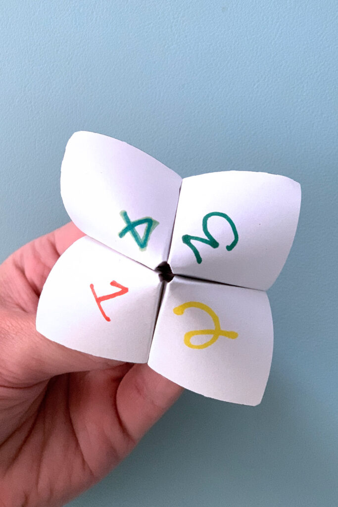 A paper fortune with corners numbered 1 through 4.