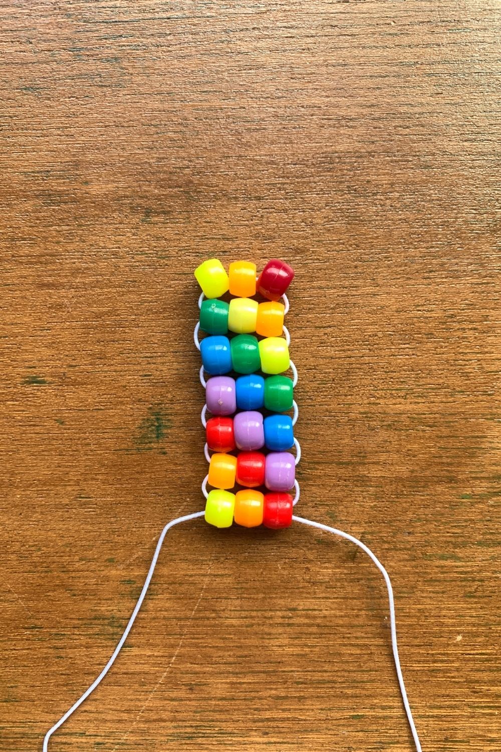 Rainbow pony bead bracelet pattern with elastic cord.