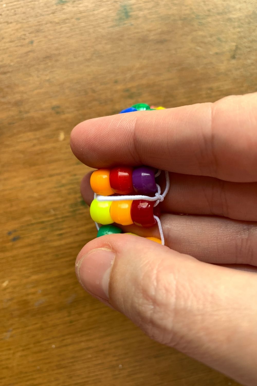 Tying the last row of beads to the first row.