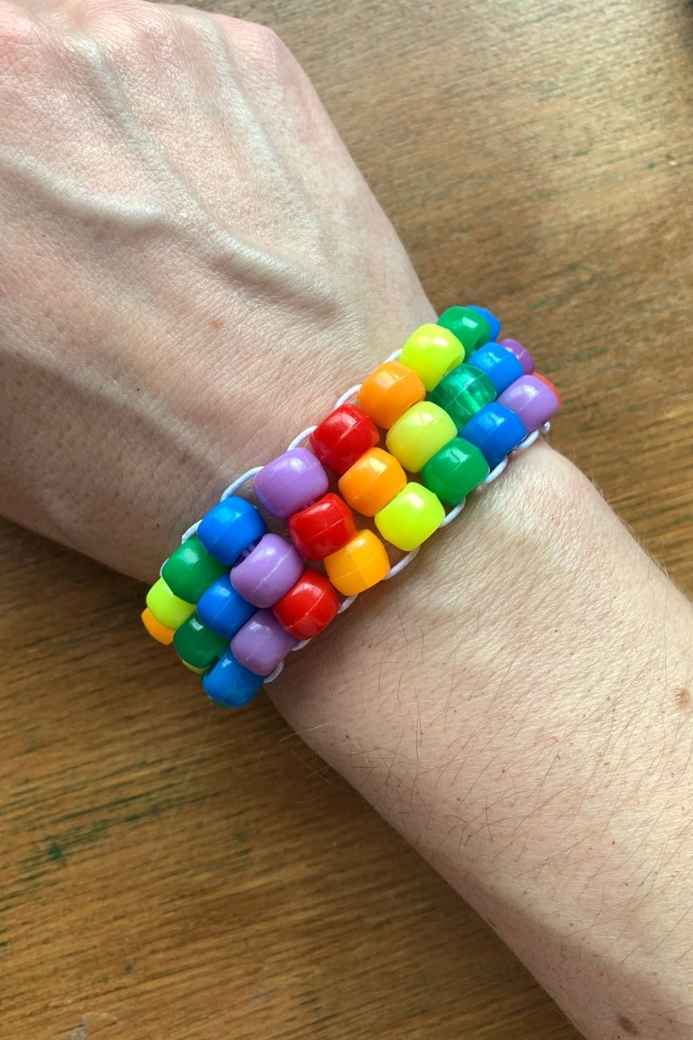 A rainbow pony bead bracelet with diagonal colors.