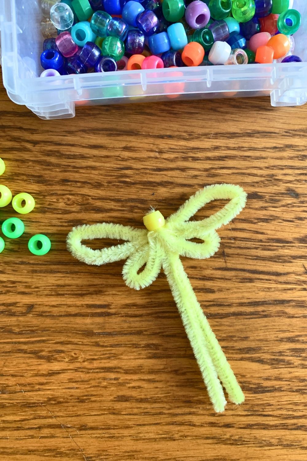 Adding a bead between the wings for a head.