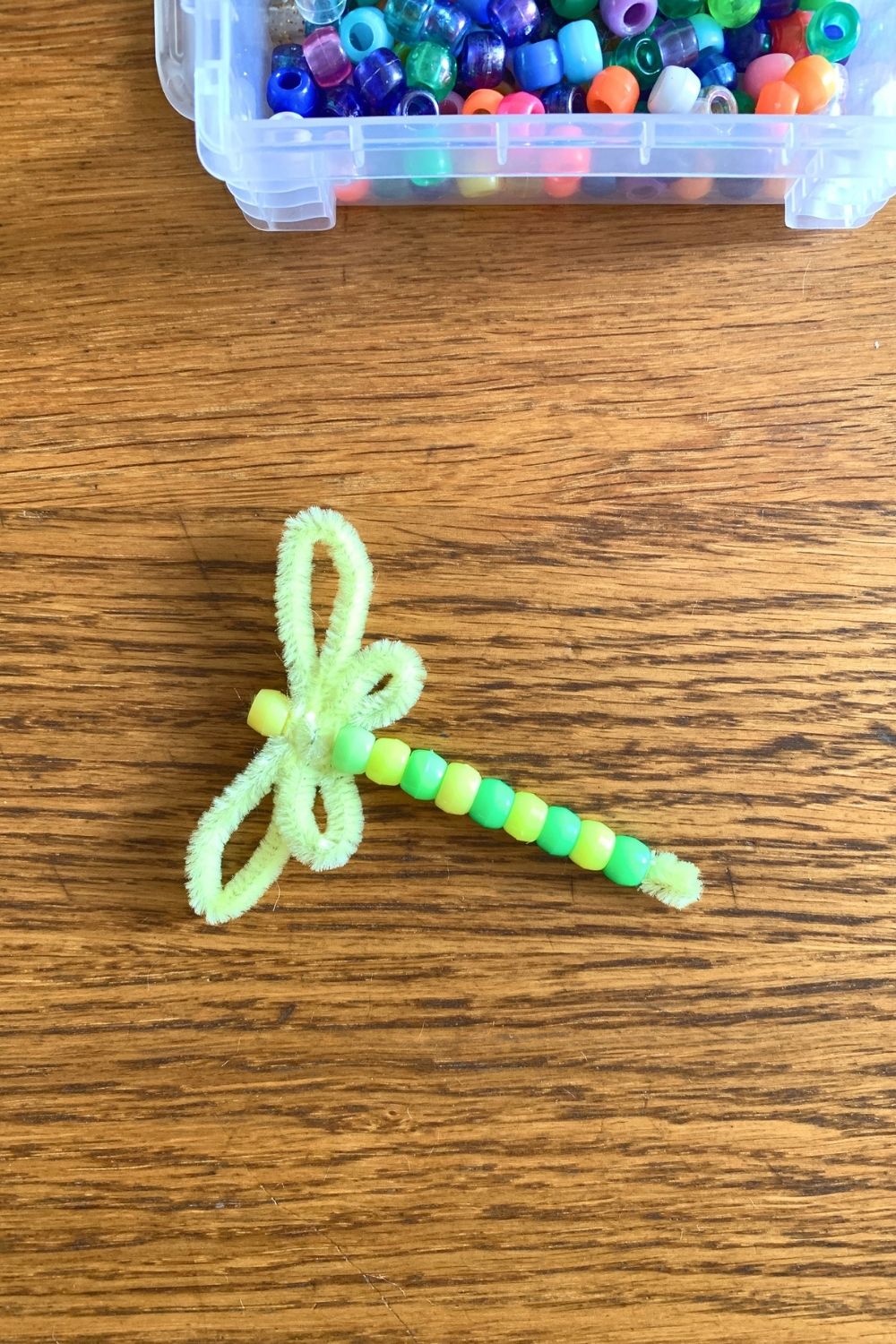 Alternating green and yellow pony beads over the center stem for the body.