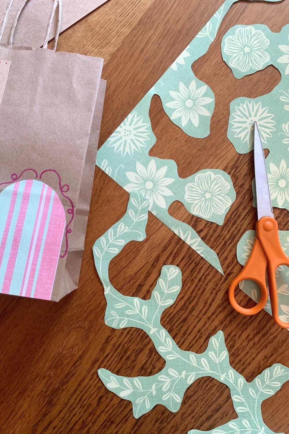 Cutting out plants on printed scrapbook paper.