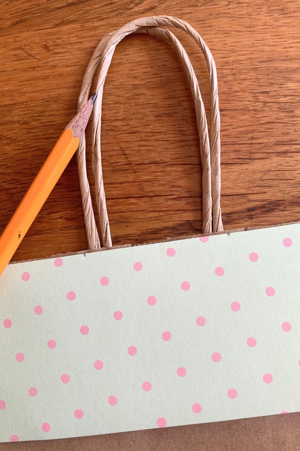 A pencil marking the handles of the bag onto the roof piece.