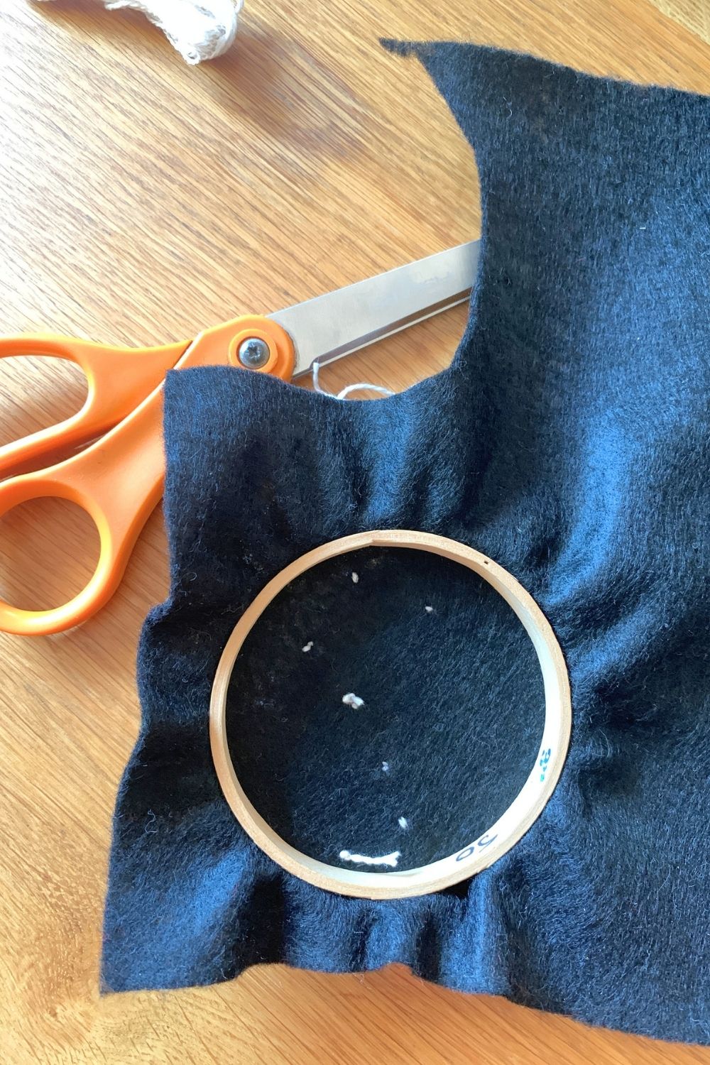 Tying a knot in the thread on the back of the felt.