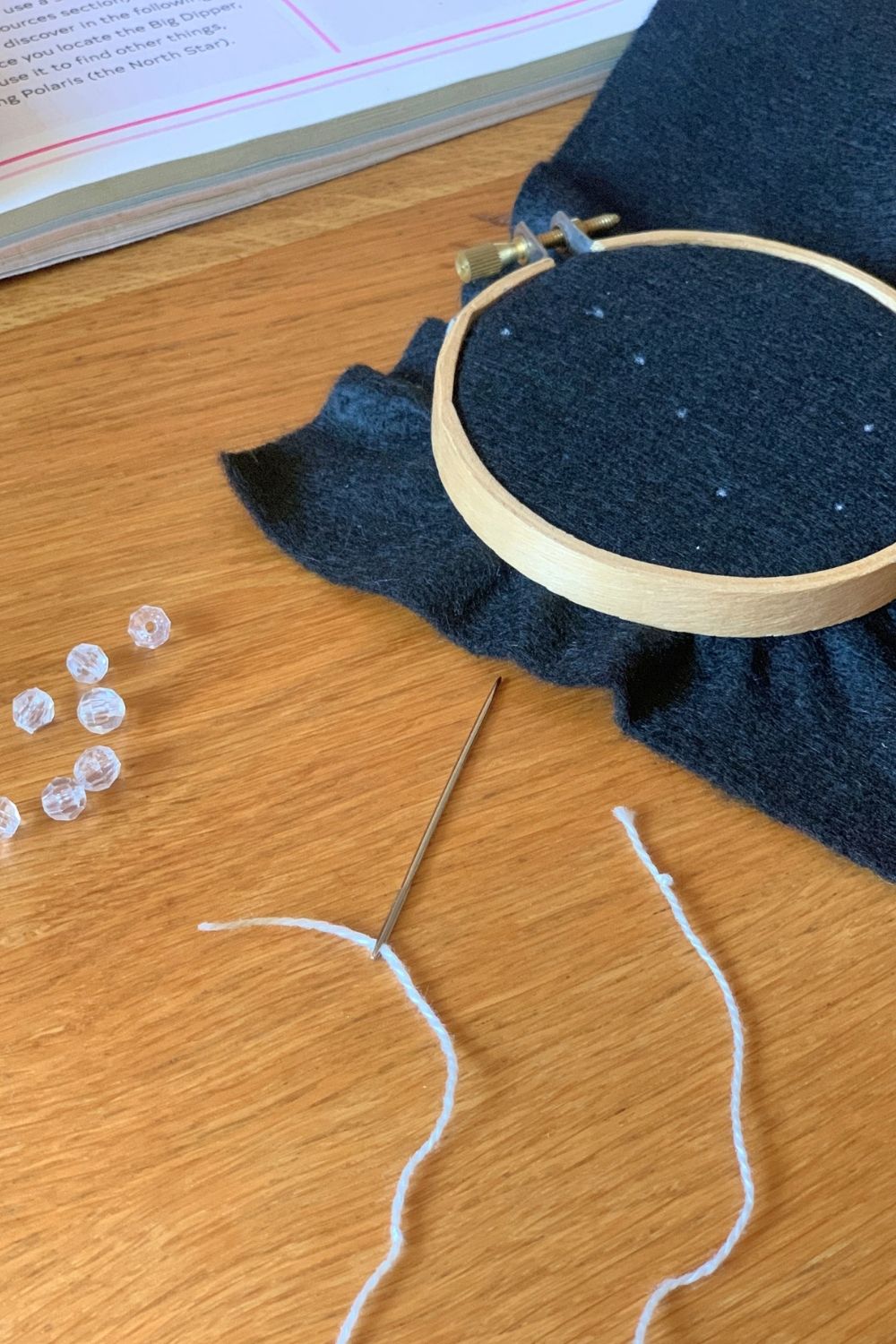 A large metal needle with white thread.
