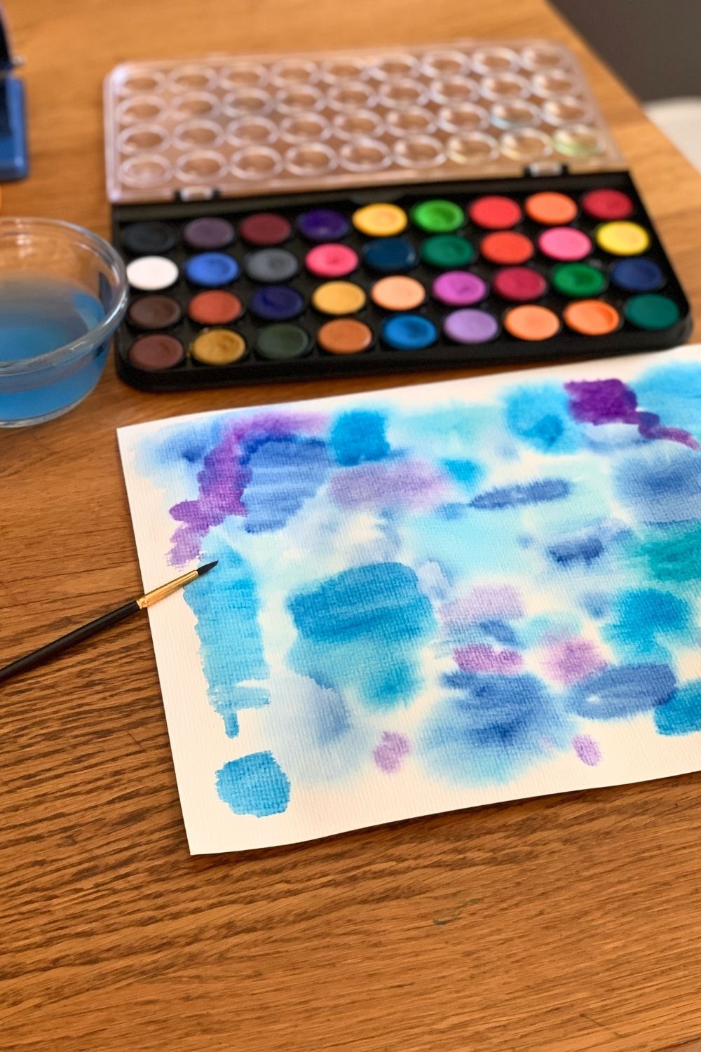 A page of watercolor blobs in blue, green, and purple.