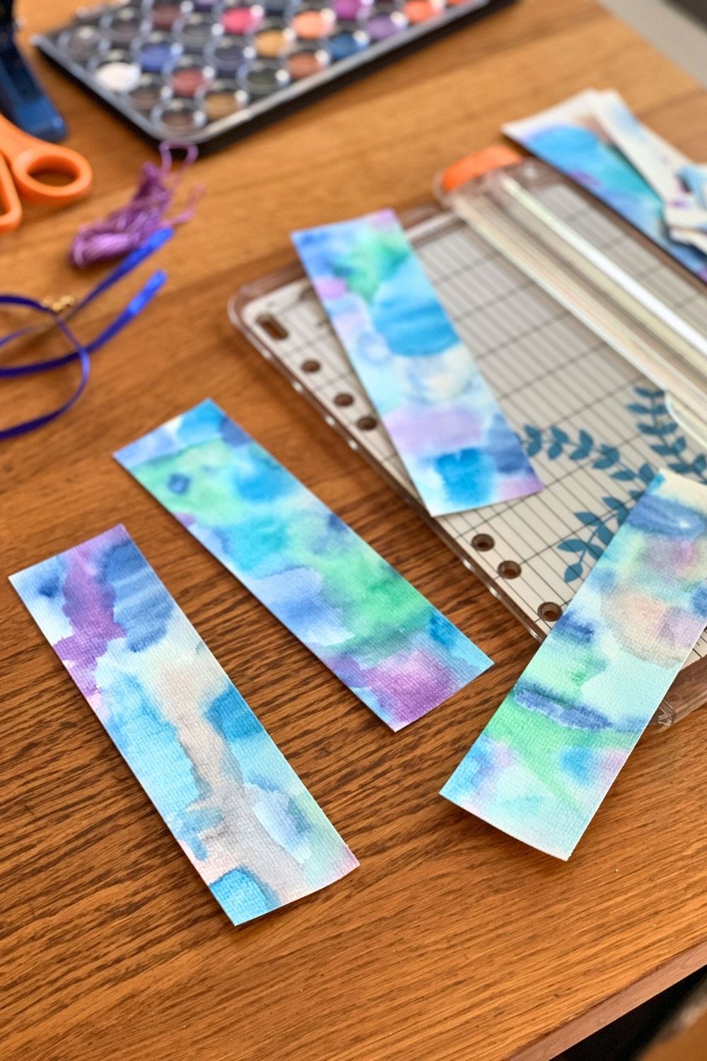 Watercolor paper cut into bookmark rectangles.