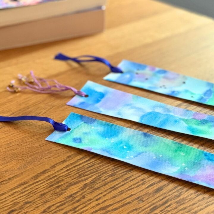 Blue watercolor bookmarks with ribbon and star bead tassels.